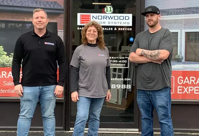 Norwood Door Systems technicians in front of the building